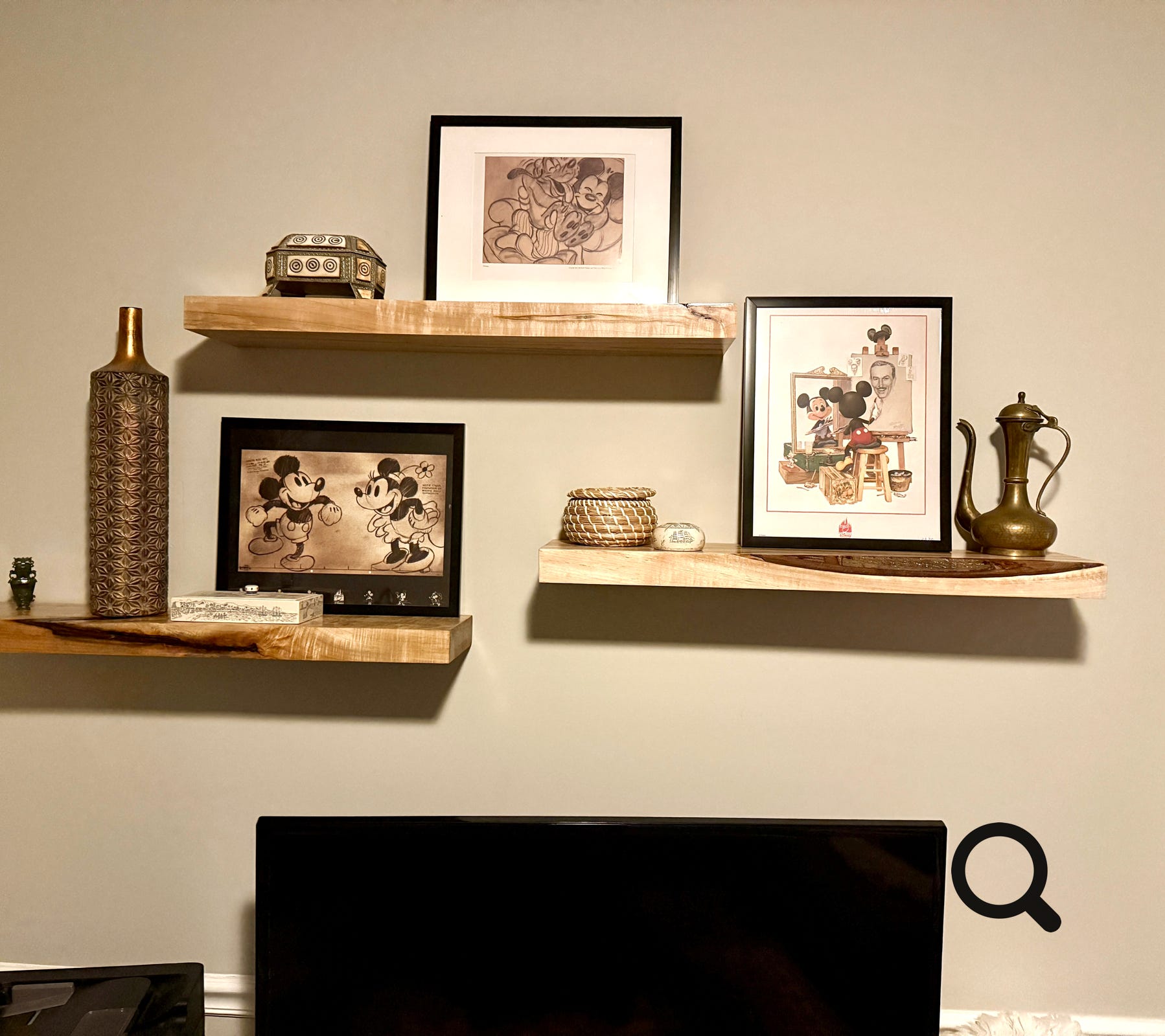 Old wooden frames lie abandoned on a sandy surface amidst scattered vegetation.