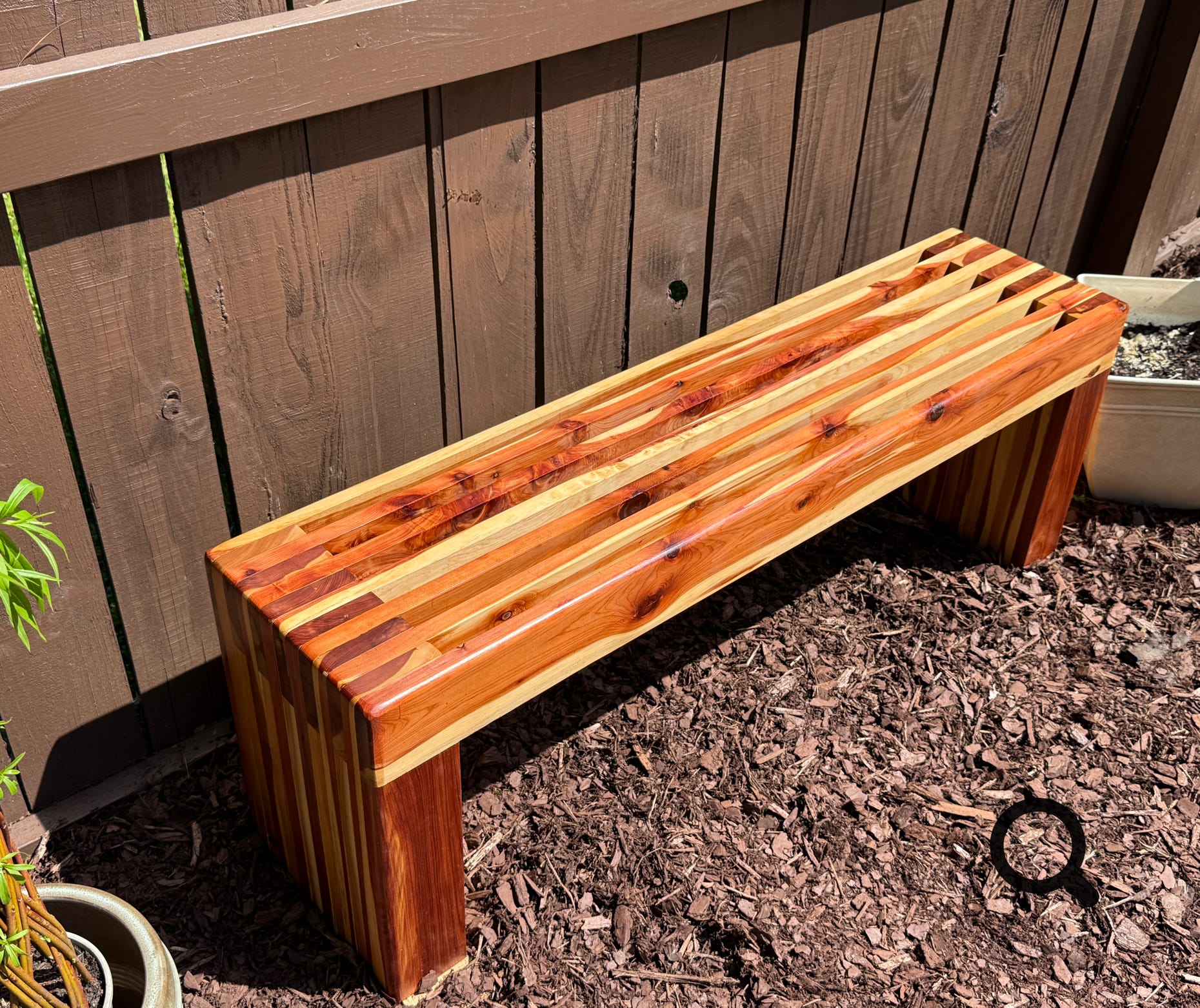 Close-up of a traditional Arabic ring with elegant calligraphy set against rustic wooden planks.